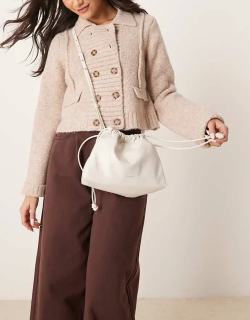 Calvin Klein Jeans Drawstring Crossbody Bag In Off White For Women Chalk